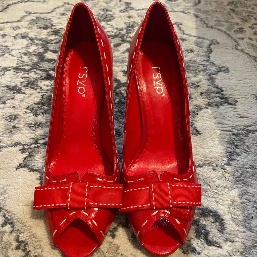 Red patent leather peep toe heels.